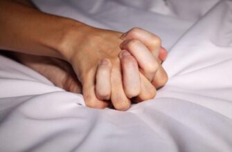 couple holding hands in bed during sex 1100x720 1