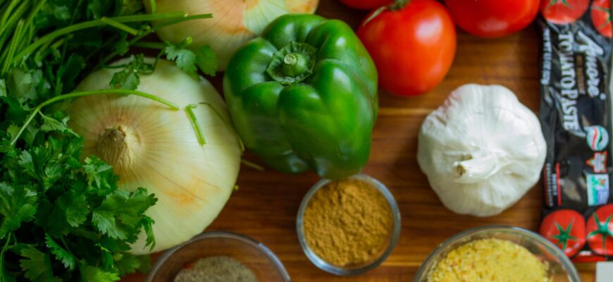 assorted vegetables and spices on wood surface