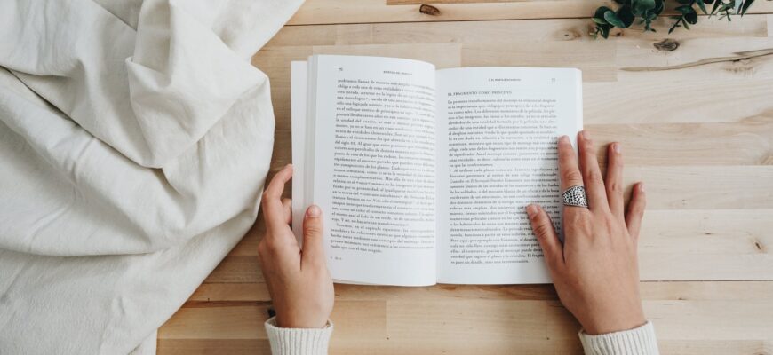 photo of person holding a book