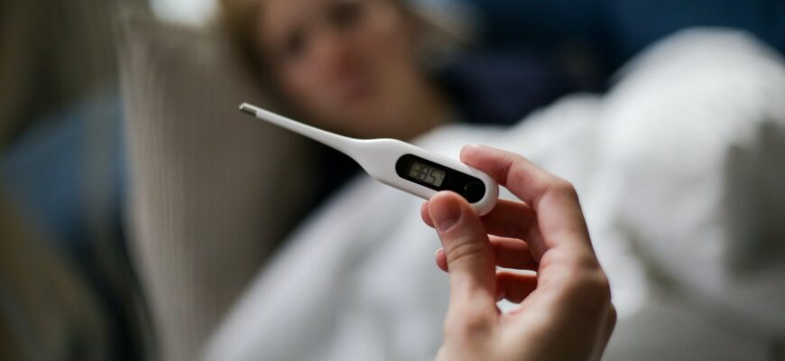 a person holding a thermometer