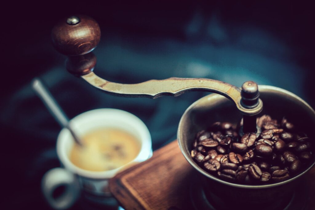 selective focus photography of vintage brown and gray coffee grinder