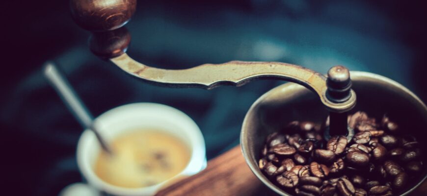selective focus photography of vintage brown and gray coffee grinder