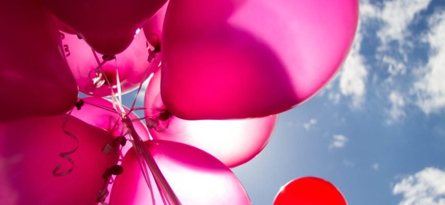 pink and red balloons during daytime