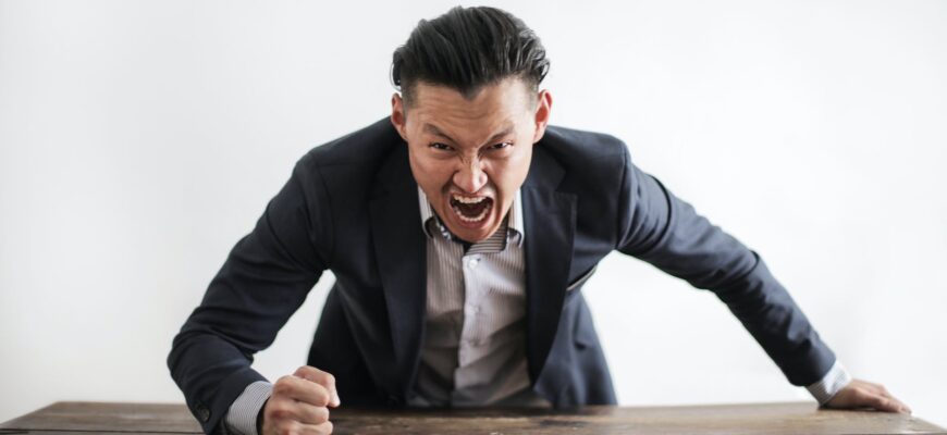 mad formal executive man yelling at camera