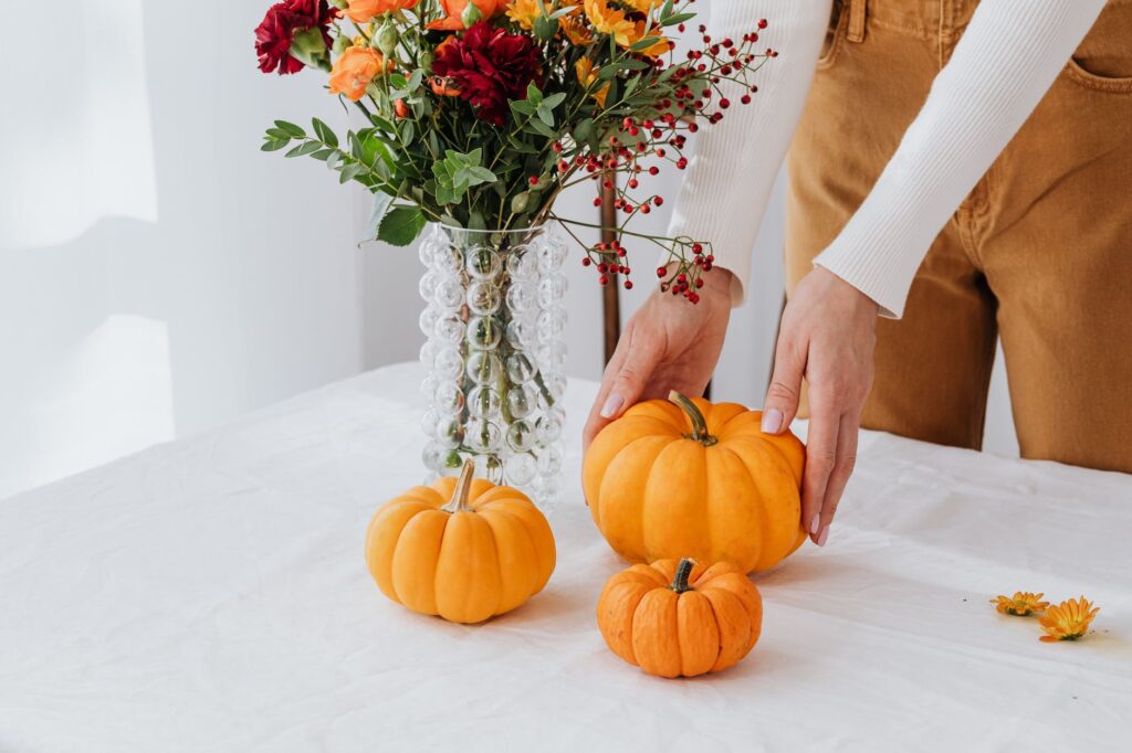 person holding orange and red flowers