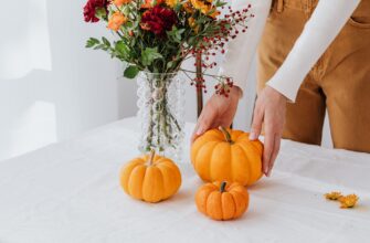 person holding orange and red flowers