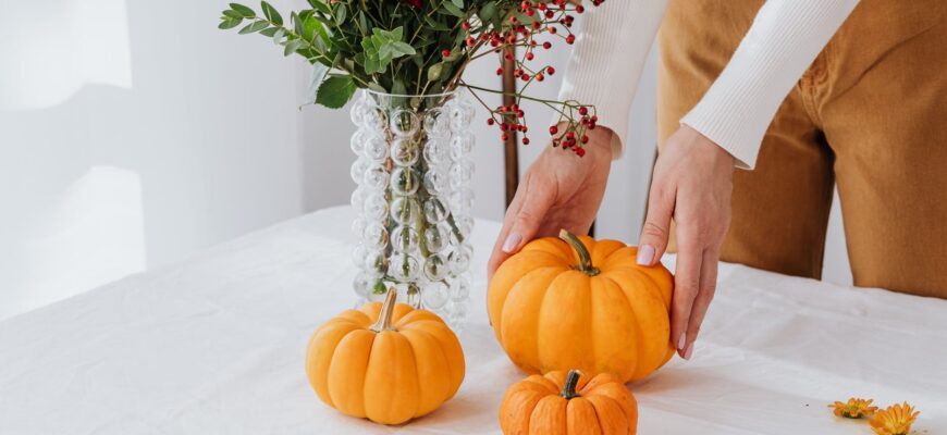 person holding orange and red flowers
