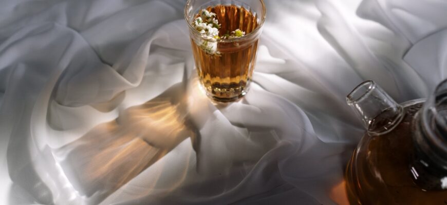 clear shot glass on white textile