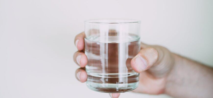 person holding drinking glass