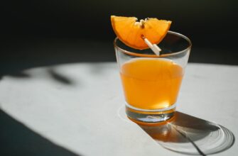 glass of orange cocktail on table