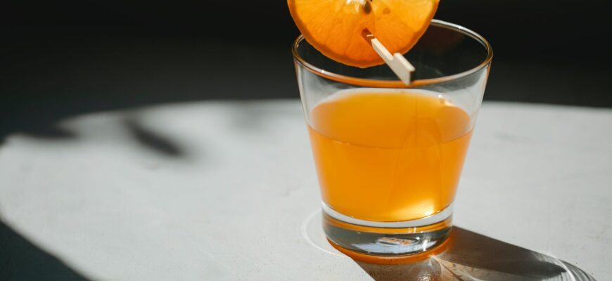 glass of orange cocktail on table
