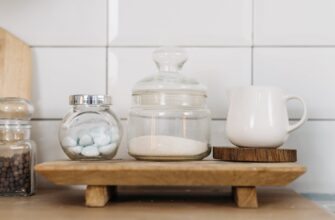 glass jars and ceramic cup on wooden coaster