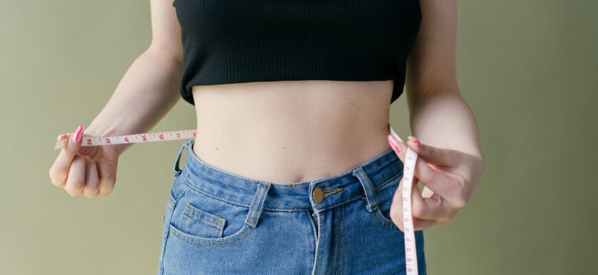 woman in black tank top and blue denim jeans