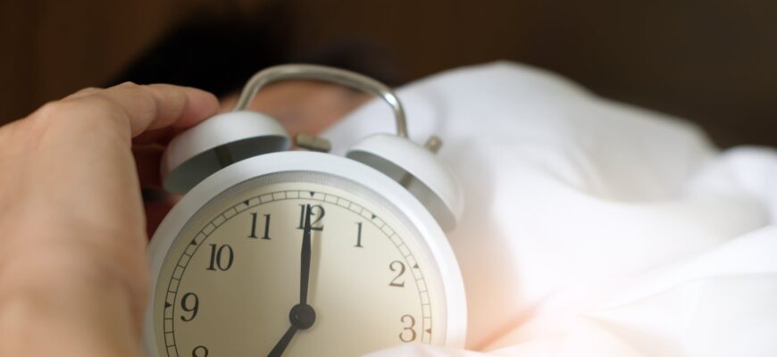 photo of person holding alarm clock