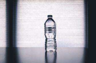 clear disposable bottle on black surface