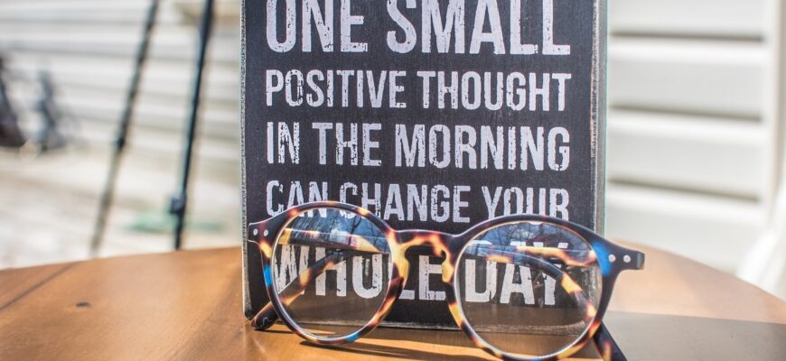 photo of a sign and eyeglasses on table