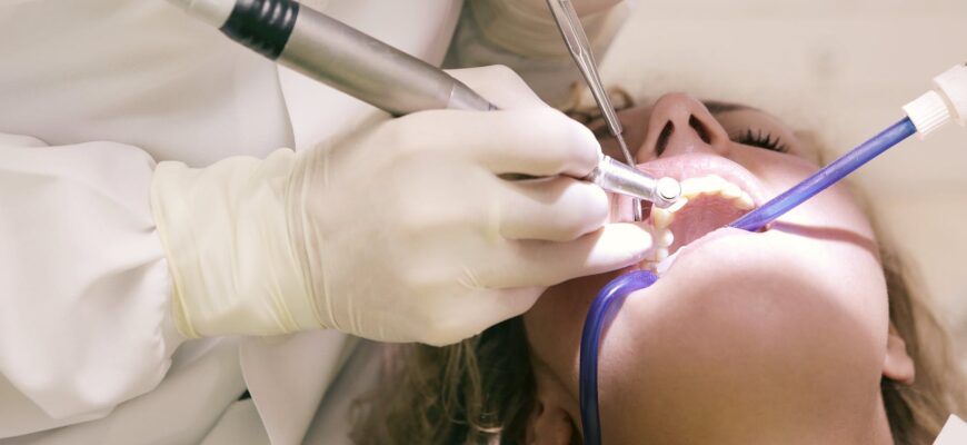 dentist working working on woman s teeth