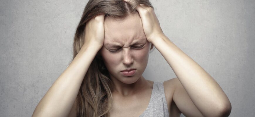woman in gray tank top showing distress