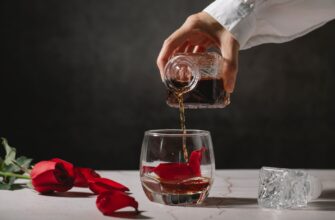 crop person pouring whiskey into glass
