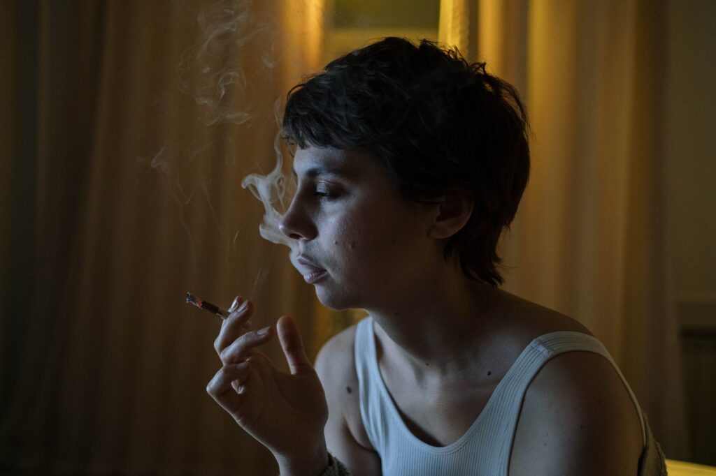 photo of a woman with short hair smoking a cigarette