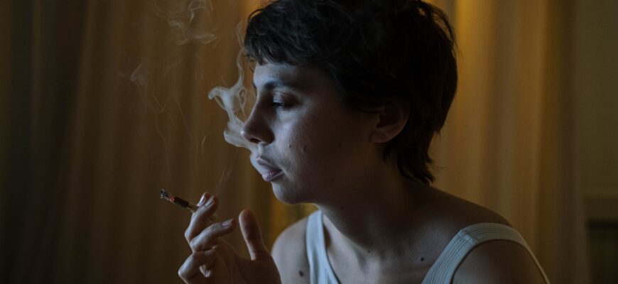 photo of a woman with short hair smoking a cigarette