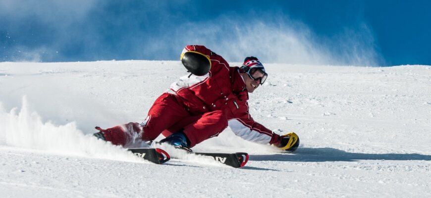 man on ski board on snow field