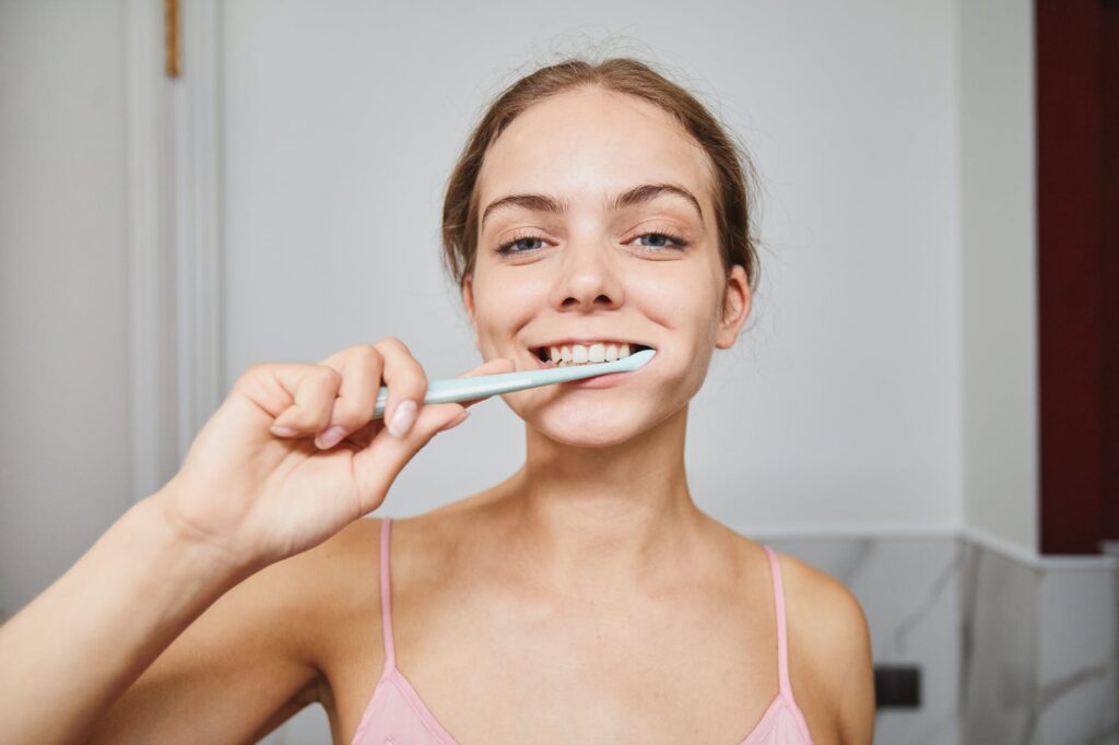 close up shot of a woman brushing her teeth
