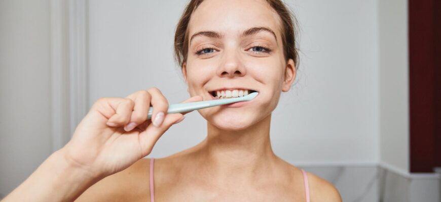 close up shot of a woman brushing her teeth