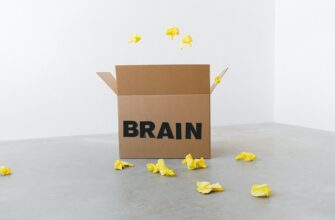 brain inscription on cardboard box under flying paper pieces
