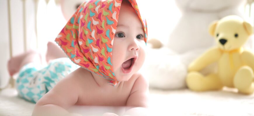 toddler wearing head scarf in bed