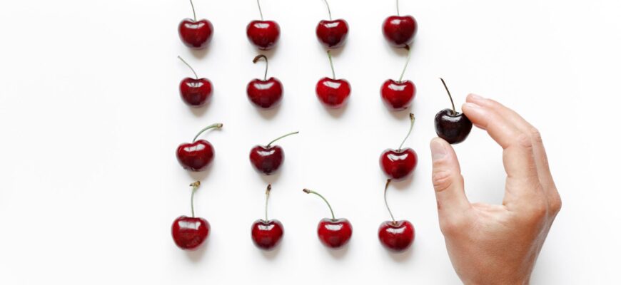 cherry on person s hand