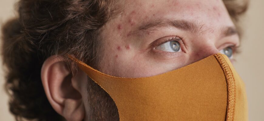 a man wearing a brown face mask