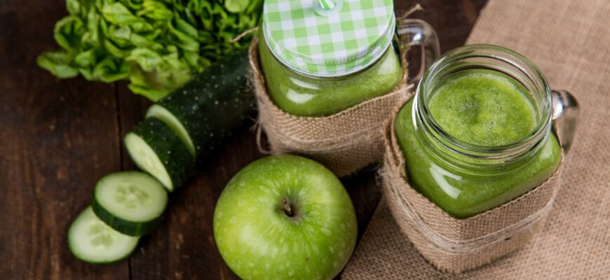 green apple beside of two clear glass jars