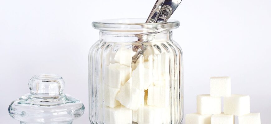 close up photo of sugar cubes in glass jar