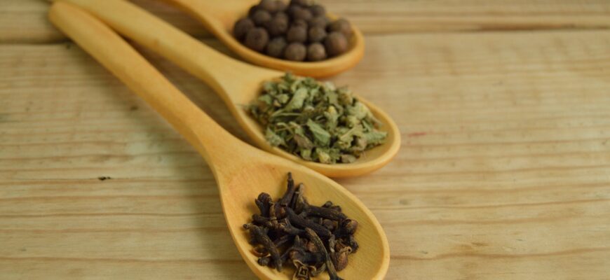 vegetables and beans on brown wooden measuring spoon