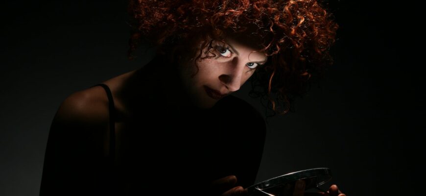 red haired woman in dark room