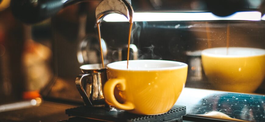 espresso machine dispensing on two mugs