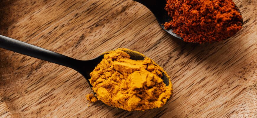 ground turmeric and hot paprika on cutting board