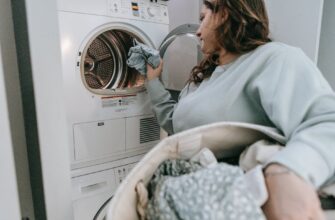 woman loading clothes in washing machine