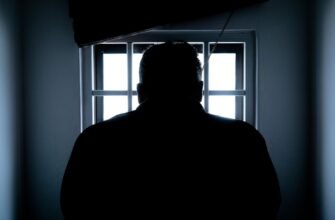rear view of a silhouette man in window