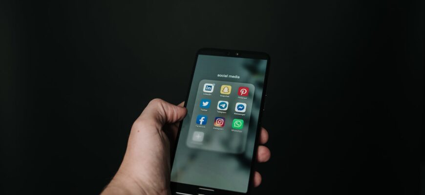 photo of hand holding a black smartphone