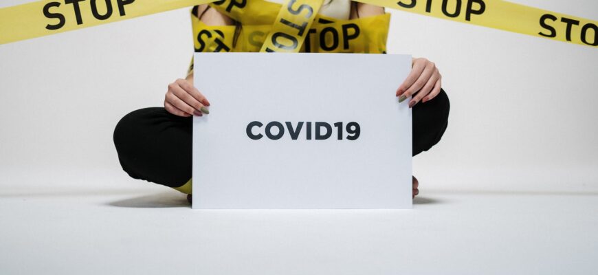 person holding covid sign