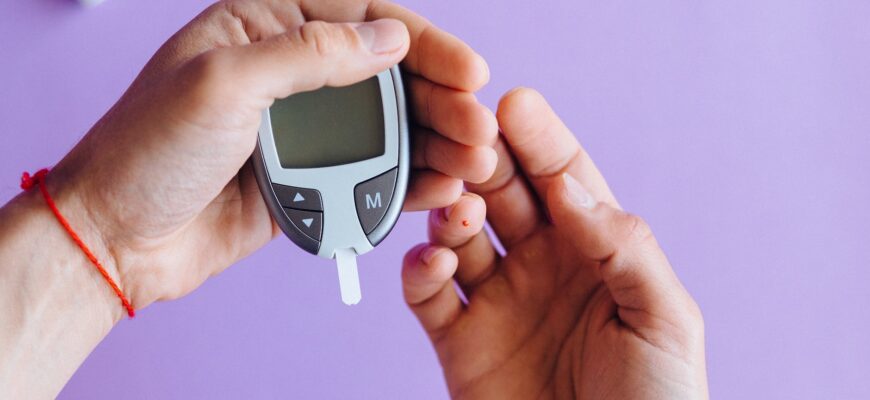 person holding a glucose meter