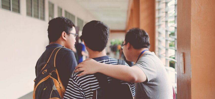three men standing near window