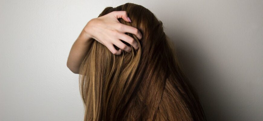 photo of woman covering face with her hair