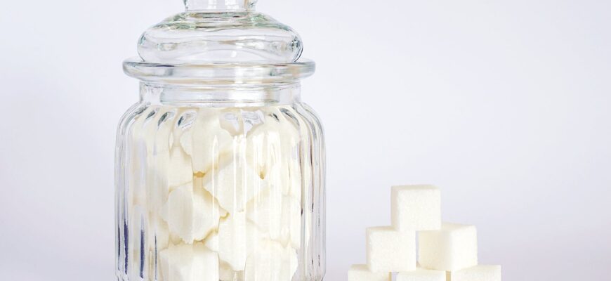 close up photo of sugar cubes in glass jar