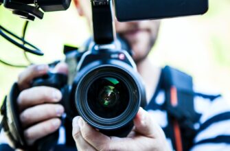 person holding canon dslr camera close up photo