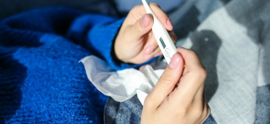 person holding thermometer