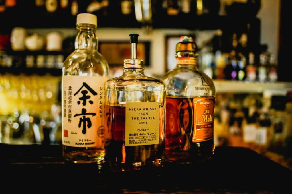 three assorted liquor bottles on table