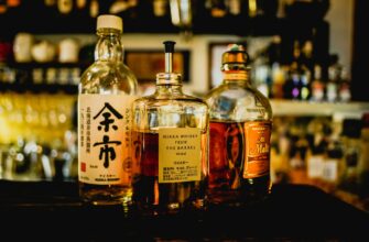three assorted liquor bottles on table